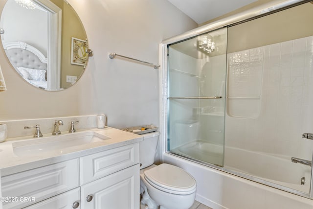 bathroom featuring toilet, vanity, and shower / bath combination with glass door