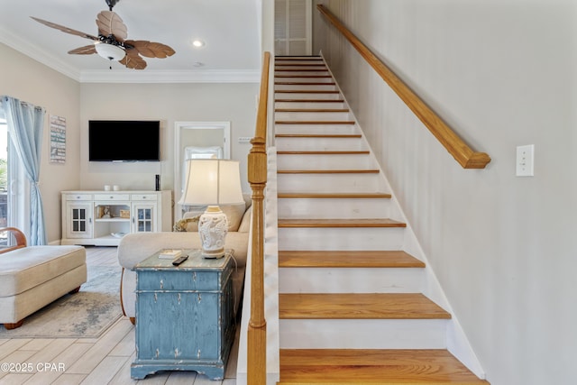 staircase with recessed lighting, ornamental molding, ceiling fan, and wood finished floors