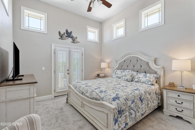 bedroom with a ceiling fan, multiple windows, light carpet, and access to exterior
