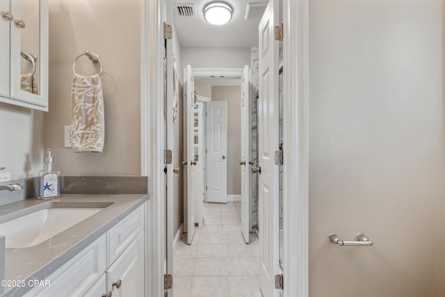 bathroom featuring tile patterned flooring, vanity, and visible vents
