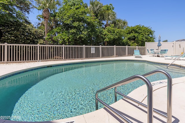 community pool featuring a patio area and fence
