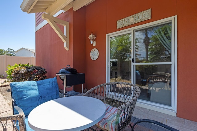 view of patio / terrace with area for grilling, outdoor dining area, and fence