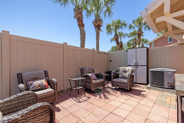 view of patio / terrace featuring an outdoor hangout area, a fenced backyard, and central AC
