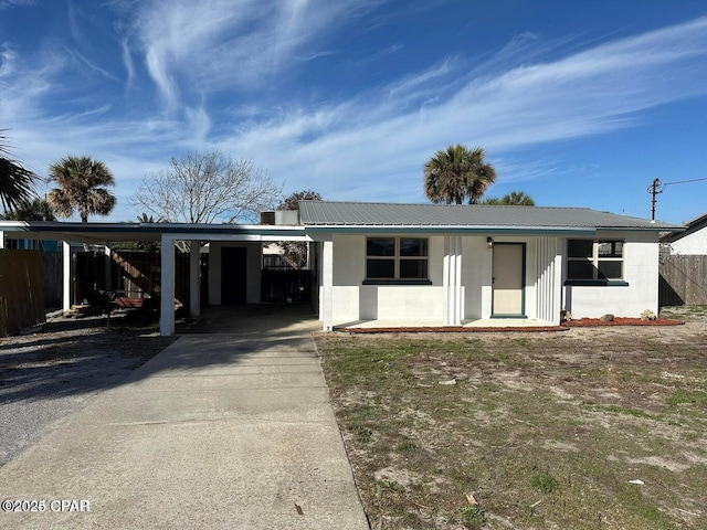 3733 Benbow St, Panama City Beach, FL 32408 - single story home with concrete block siding, a carport, driveway, and metal roof