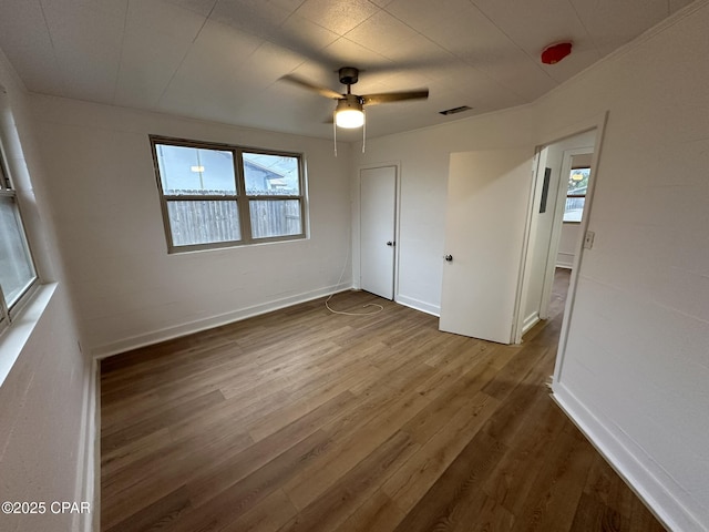 3733 Benbow St, Panama City Beach, FL 32408 - unfurnished bedroom with dark wood finished floors, baseboards, and ceiling fan