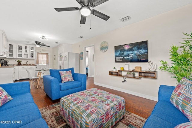 4025 Venus St, Panama City Beach, FL 32408 - living area featuring visible vents, baseboards, ceiling fan, and dark wood-type flooring