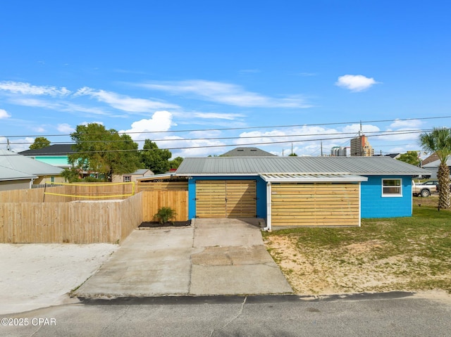 4025 Venus St, Panama City Beach, FL 32408 - view of front facade with metal roof and fence