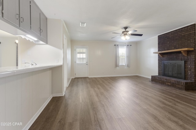3947 Verona Cir, Panama City, FL 32405 - unfurnished living room with plenty of natural light, light wood finished floors, ceiling fan, and a fireplace