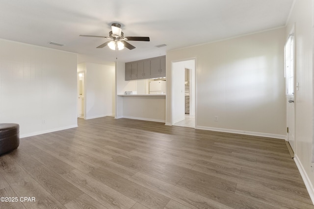 3947 Verona Cir, Panama City, FL 32405 - unfurnished living room featuring visible vents, a ceiling fan, baseboards, and wood finished floors