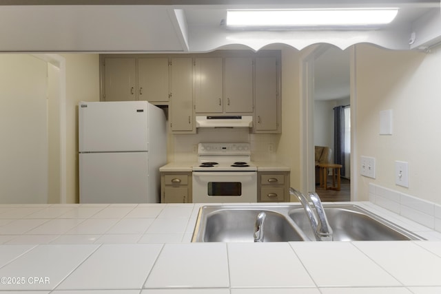 3947 Verona Cir, Panama City, FL 32405 - kitchen with white appliances, tile countertops, under cabinet range hood, a sink, and gray cabinetry