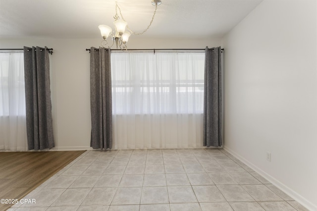 3947 Verona Cir, Panama City, FL 32405 - spare room with an inviting chandelier, baseboards, and light tile patterned flooring