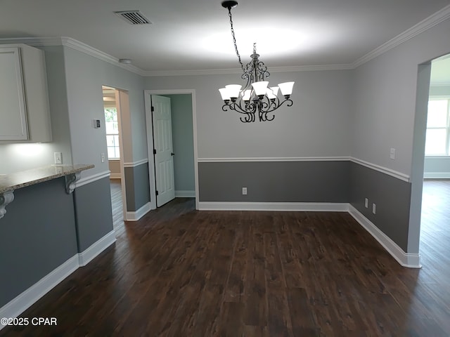 2525 E 40th Ct, Panama City, FL 32405 - unfurnished dining area with a notable chandelier, dark wood-style floors, and plenty of natural light