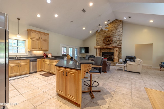 kitchen featuring plenty of natural light, dark countertops, ceiling fan, and open floor plan