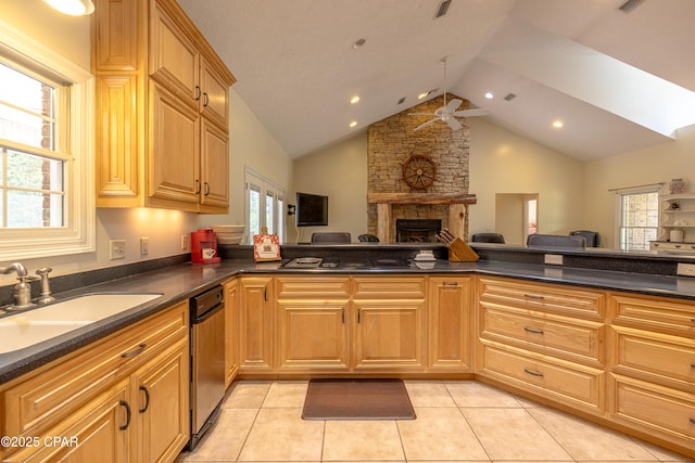 kitchen featuring dark countertops, a fireplace, a sink, high vaulted ceiling, and open floor plan