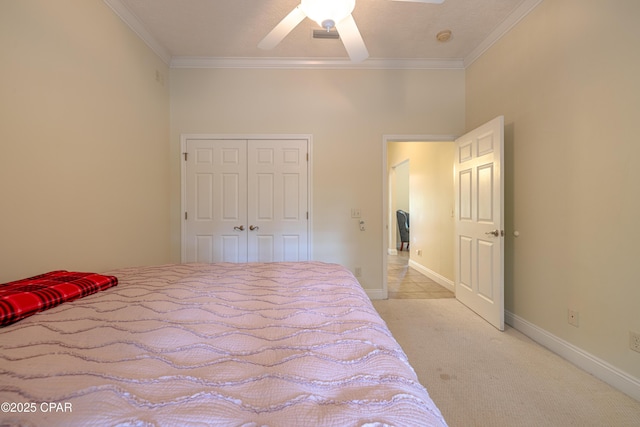 bedroom with ornamental molding, light carpet, a closet, and ceiling fan