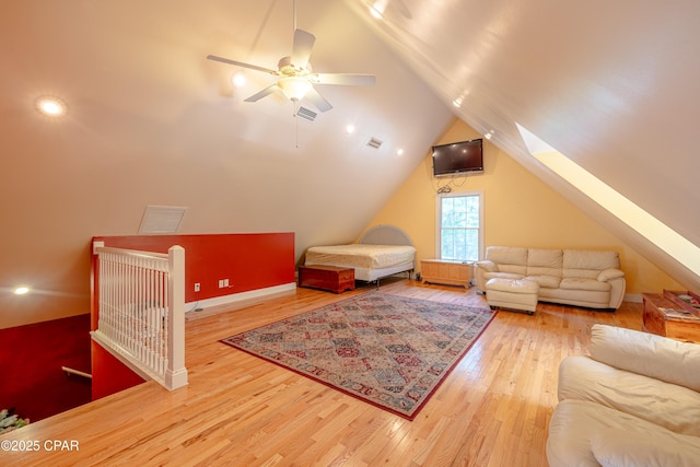 interior space featuring visible vents, lofted ceiling with skylight, and wood finished floors