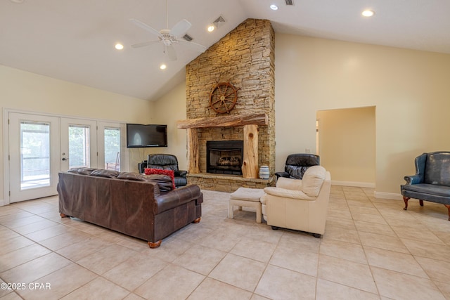 living room with ceiling fan, visible vents, a fireplace, high vaulted ceiling, and light tile patterned flooring