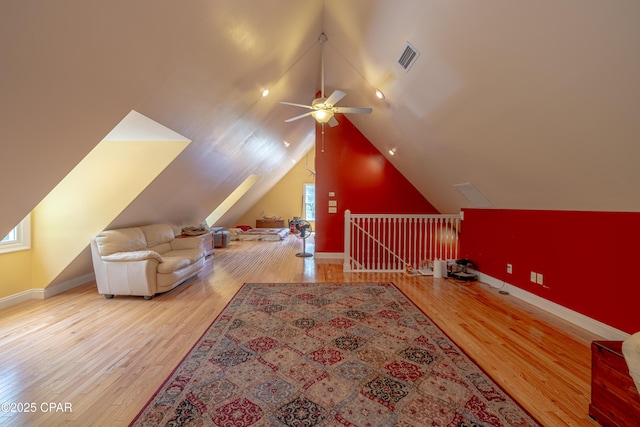 bonus room with a ceiling fan, baseboards, wood finished floors, and lofted ceiling
