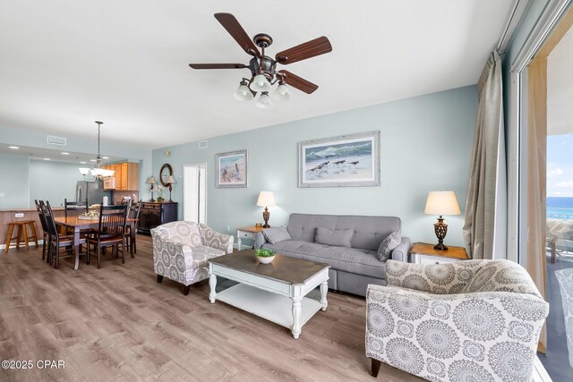 17739 Front Beach Rd Unit 1207W, Panama City Beach, FL 32413 - living area with light wood-type flooring, visible vents, and a ceiling fan