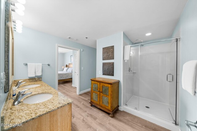 17739 Front Beach Rd Unit 1207W, Panama City Beach, FL 32413 - ensuite bathroom with a stall shower, a sink, ensuite bathroom, and wood finished floors