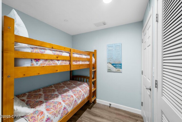 17739 Front Beach Rd Unit 1207W, Panama City Beach, FL 32413 - bedroom featuring baseboards, visible vents, and wood finished floors