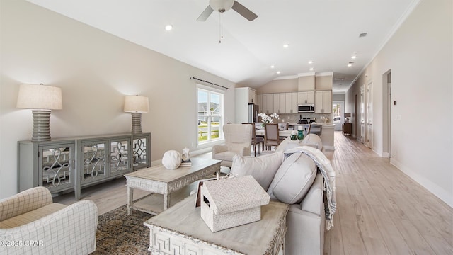 845 Walsonham Dr, Panama City Beach, FL 32407 - living room featuring vaulted ceiling, ceiling fan, light wood-style floors, baseboards, and crown molding