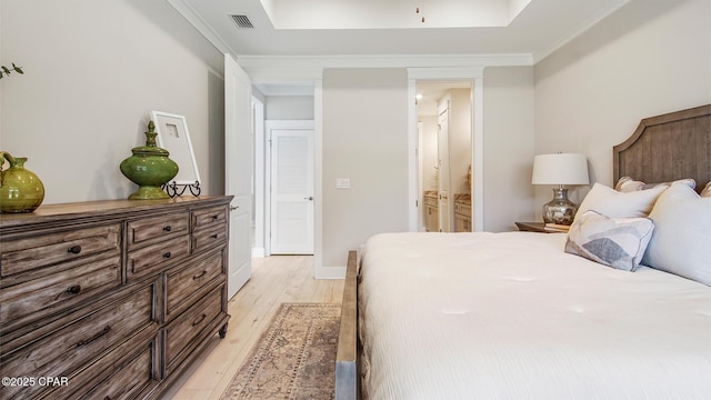 845 Walsonham Dr, Panama City Beach, FL 32407 - bedroom with light wood-style floors, a raised ceiling, ensuite bathroom, and crown molding