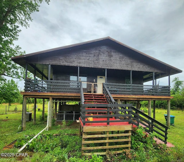 14235 NW Henry Grantham Rd, Altha, FL 32421 - back of property with stairway, a deck, a yard, and central AC