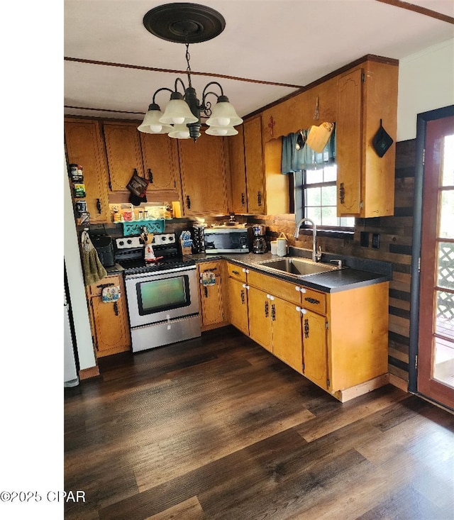 14235 NW Henry Grantham Rd, Altha, FL 32421 - kitchen with a sink, dark wood-style flooring, brown cabinetry, and appliances with stainless steel finishes