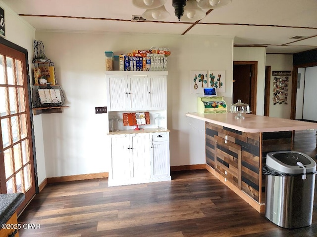 bar featuring a healthy amount of sunlight, baseboards, and dark wood finished floors