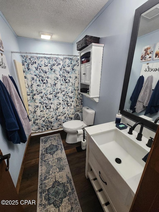 full bathroom with vanity, toilet, a textured ceiling, wood finished floors, and a shower with curtain