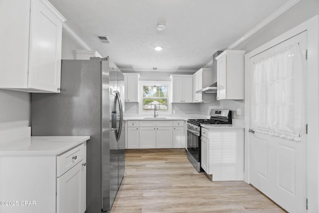871 2nd St, Chipley, FL 32428 - kitchen with appliances with stainless steel finishes, under cabinet range hood, crown molding, a sink, and white cabinets