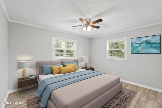 871 2nd St, Chipley, FL 32428 - bedroom featuring multiple windows, light wood-style floors, crown molding, and baseboards