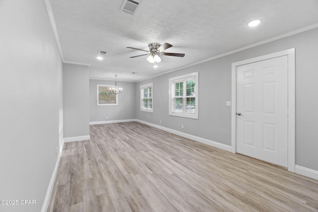 871 2nd St, Chipley, FL 32428 - spare room featuring ornamental molding, light wood-type flooring, a chandelier, a ceiling fan, and a textured ceiling