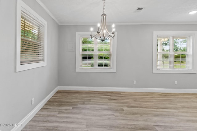 871 2nd St, Chipley, FL 32428 - unfurnished room with plenty of natural light, a chandelier, crown molding, and baseboards