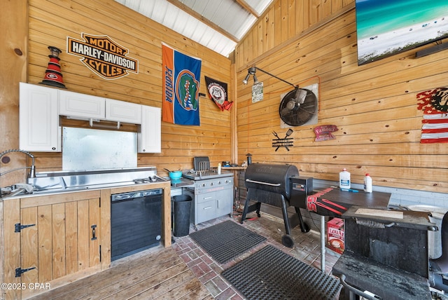 2612 NW County Road 274, Fountain, FL 32438 - kitchen with wood walls, white cabinetry, and stainless steel countertops