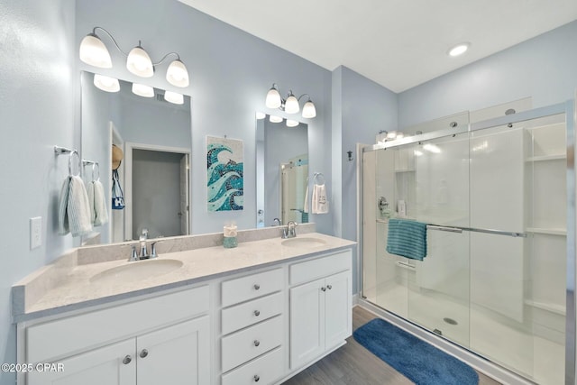 1294 Conolly Blvd, Lynn Haven, FL 32444 - full bathroom featuring a stall shower, double vanity, and wood finished floors