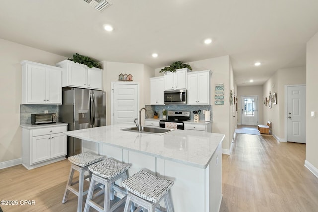 1294 Conolly Blvd, Lynn Haven, FL 32444 - kitchen with appliances with stainless steel finishes, a sink, decorative backsplash, light wood-style floors, and recessed lighting