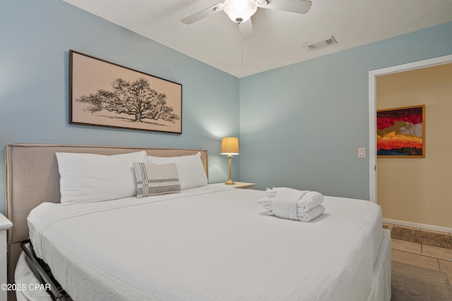 bedroom featuring baseboards, a ceiling fan, and tile patterned floors