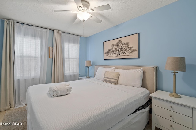 bedroom with a textured ceiling and ceiling fan