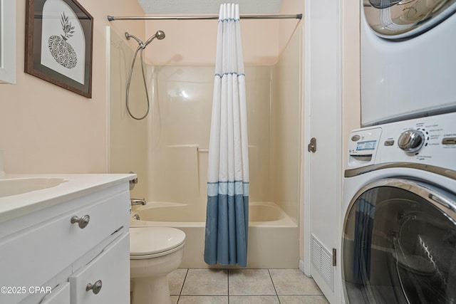 full bathroom with stacked washer and clothes dryer, shower / bath combo with shower curtain, tile patterned flooring, toilet, and vanity
