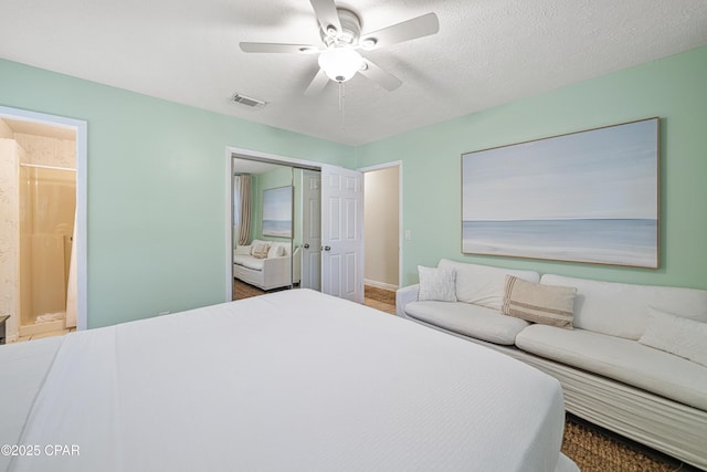 bedroom featuring ensuite bath and a ceiling fan