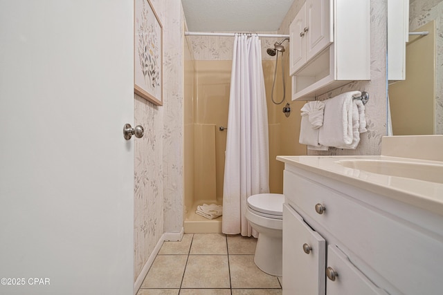 bathroom featuring tile patterned floors, toilet, a stall shower, vanity, and baseboards