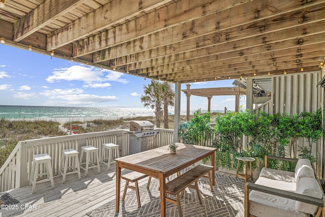 wooden deck featuring view of water and beach and area for grilling