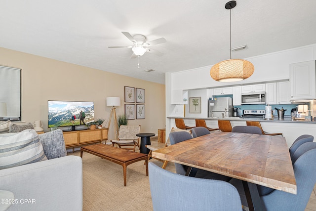 dining space featuring ceiling fan