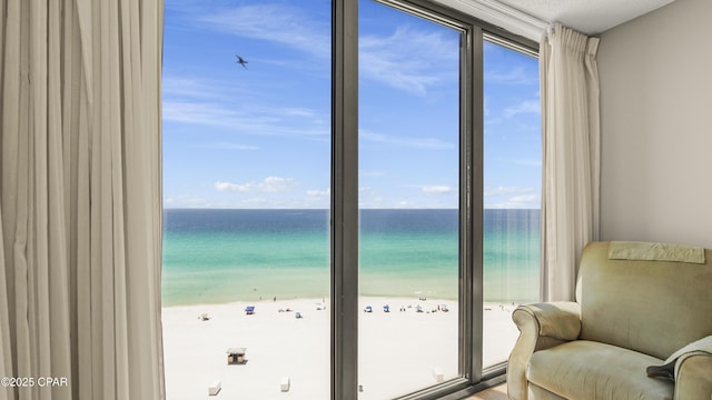 doorway featuring view of water and beach