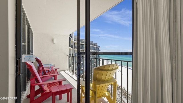 balcony with view of water and beach