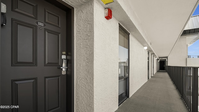 view of exterior entry featuring stucco siding
