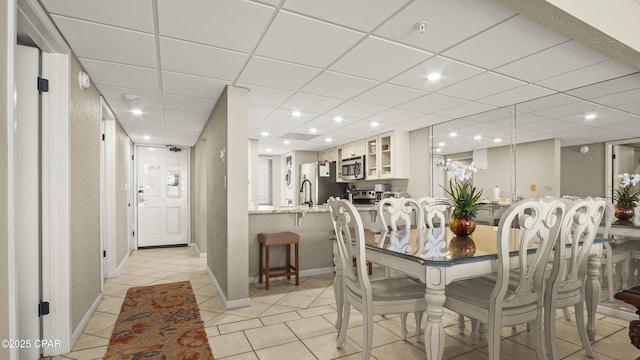 dining area with baseboards, light tile patterned floors, and recessed lighting