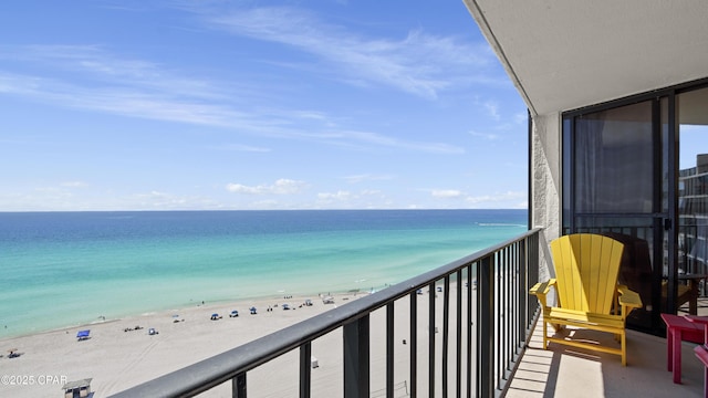 balcony featuring view of water and beach